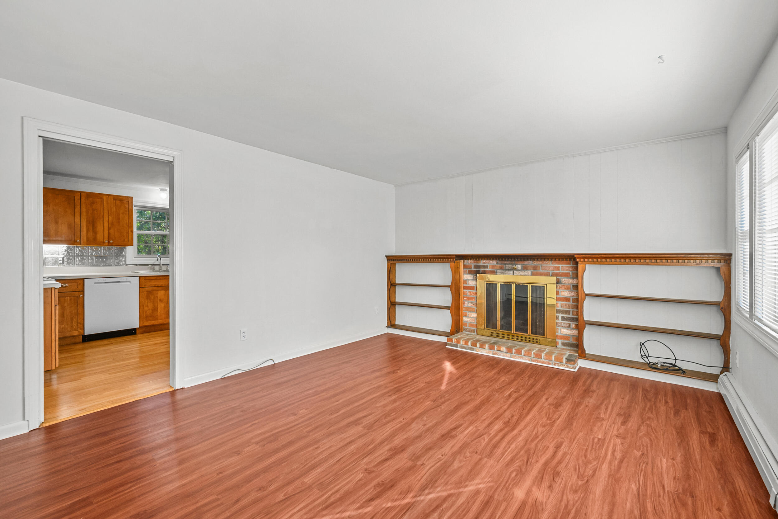 370 Compass Circle Hyannis, MA 02601 - Photo 5 of 26 a view of an empty room with wooden floor and a window