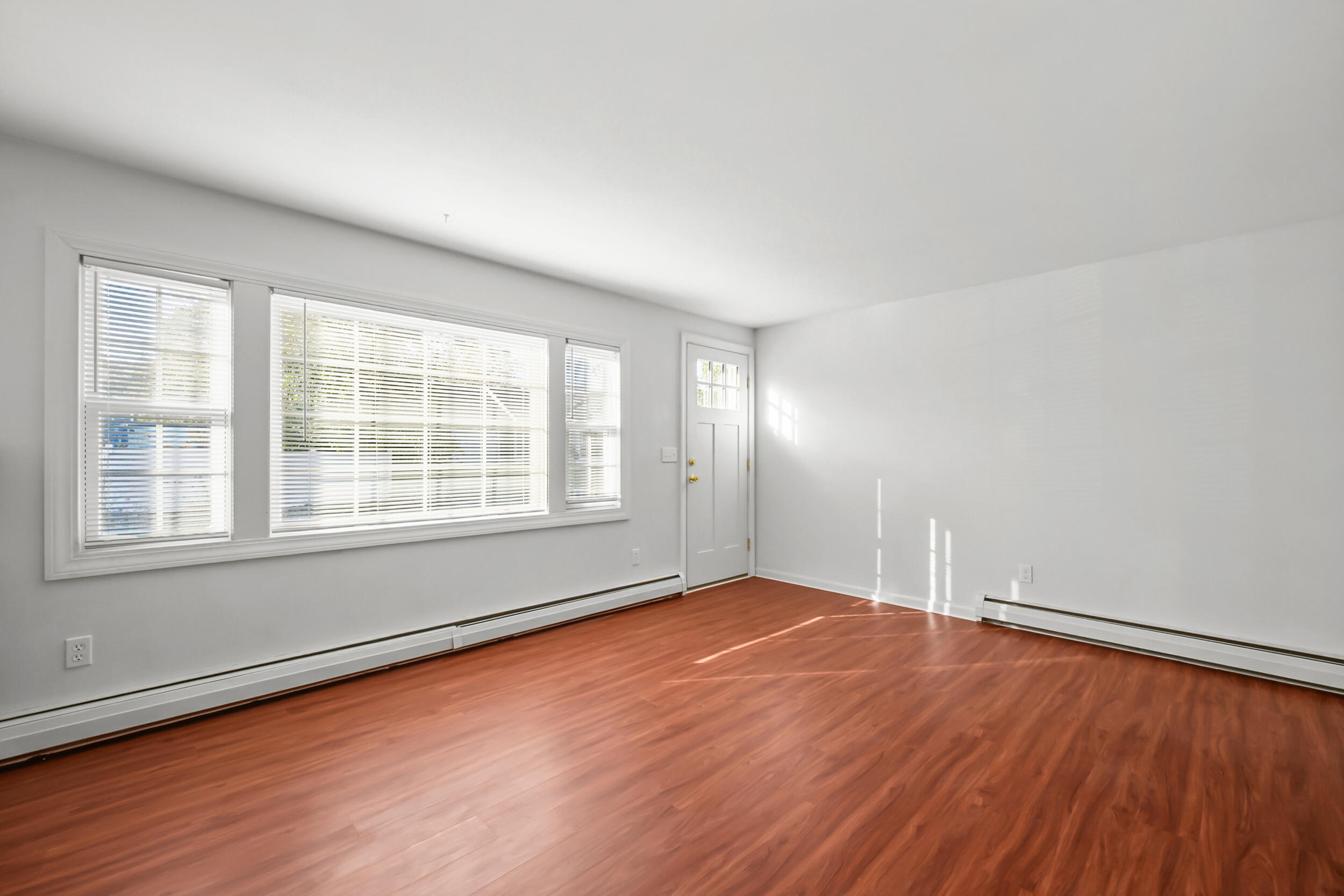 370 Compass Circle Hyannis, MA 02601 - Photo 6 of 26 an empty room with wooden floor and windows