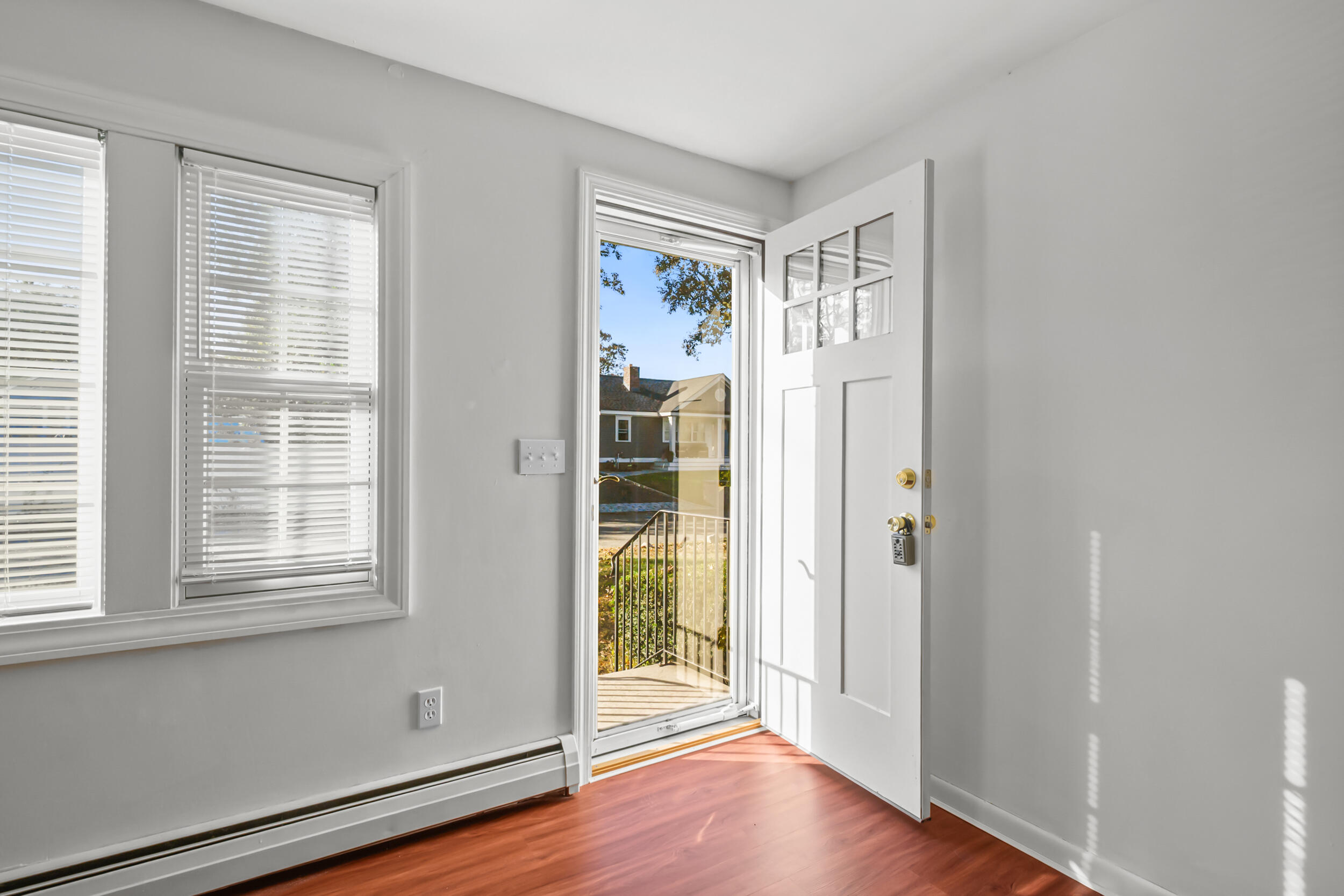 370 Compass Circle Hyannis, MA 02601 - Photo 7 of 26 an empty room with wooden floor and windows
