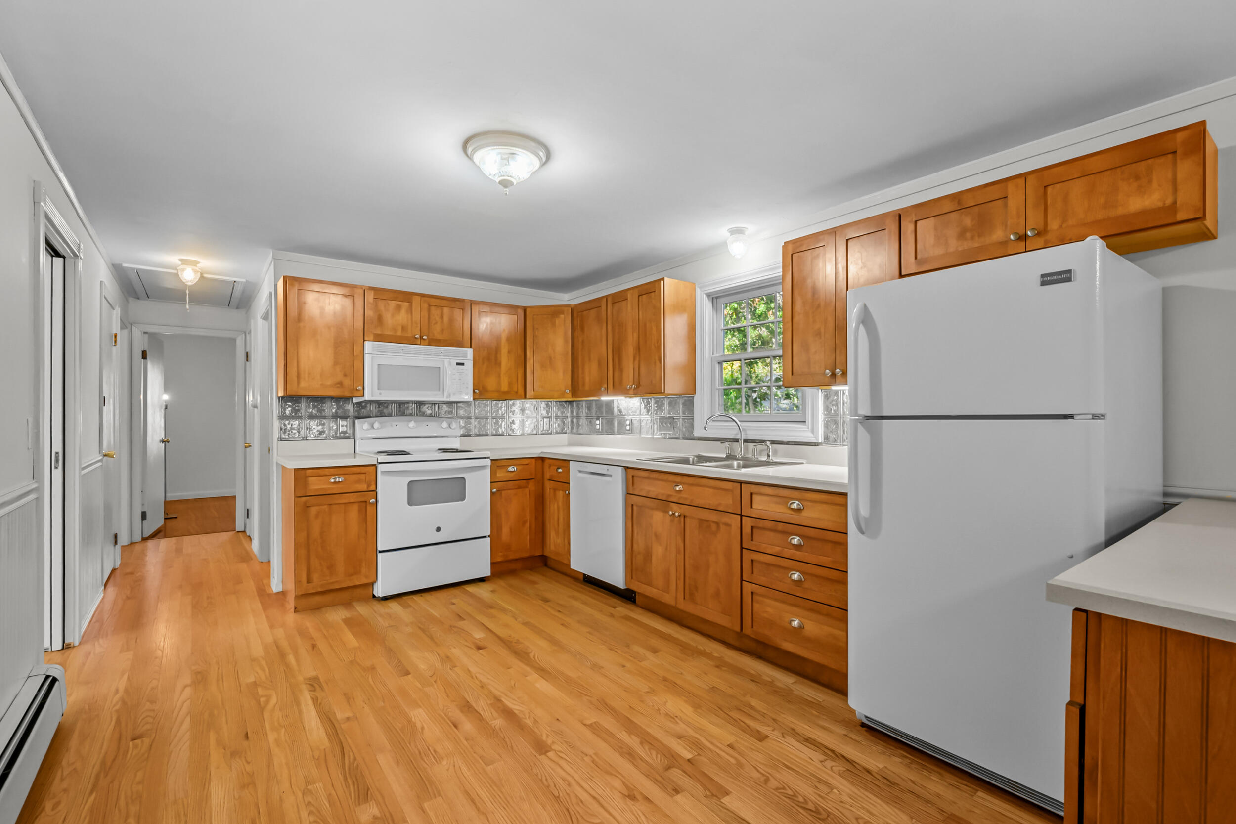 370 Compass Circle Hyannis, MA 02601 - Photo 8 of 26 a kitchen with stainless steel appliances granite countertop a refrigerator sink and wooden cabinets