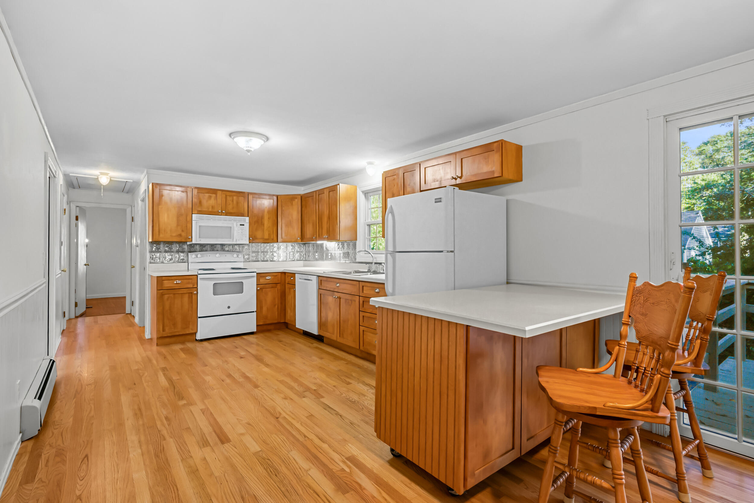 370 Compass Circle Hyannis, MA 02601 - Photo 9 of 26 a kitchen with a sink cabinets and wooden floor