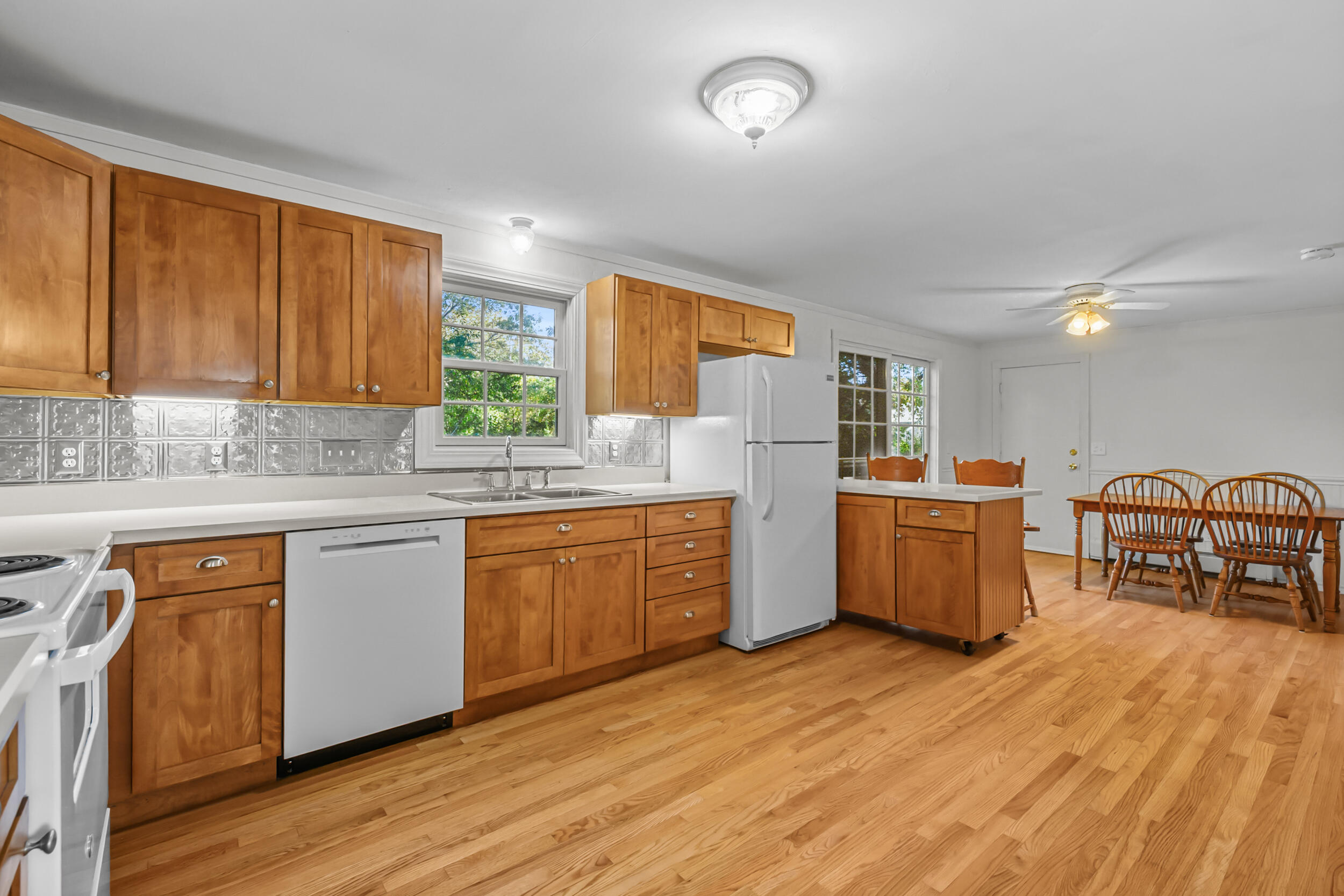 370 Compass Circle Hyannis, MA 02601 - Photo 10 of 26 a kitchen with stainless steel appliances sink refrigerator table and chairs