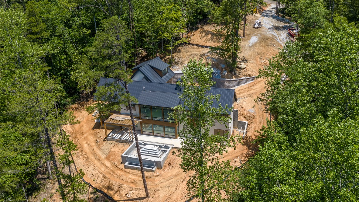 166 Ellenburg Creek Road Sunset, SC 29685 - Photo 3 of 20 Perched among verdant trees, this modern home blends seamlessly with its natural surroundings, offering a secluded retreat.