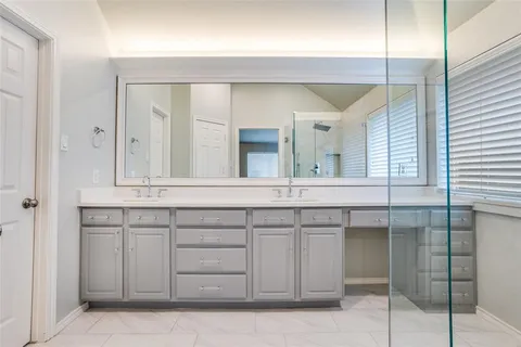 a bathroom with a sink vanity and mirror