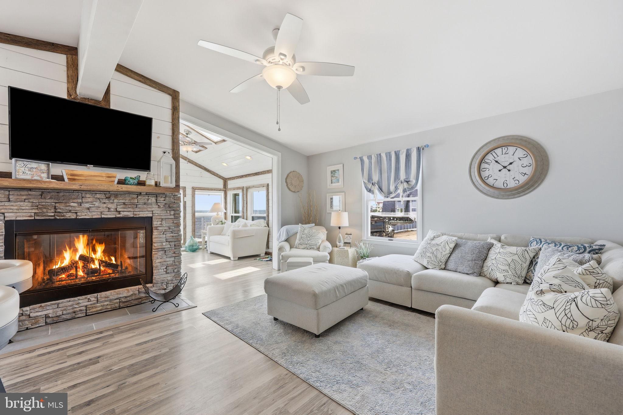 173 Cove Road Newport, NJ 08345 - Photo 6 of 72 a living room with furniture a flat screen tv and a fireplace