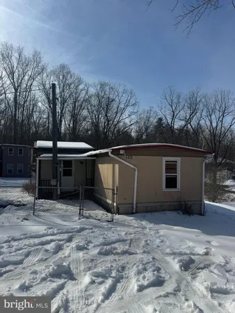 a view of backyard with barbeque grill and wooden fence
