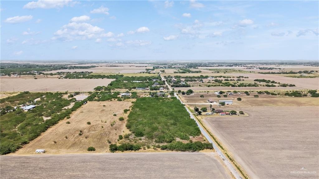 29246 26th Road San Benito, TX 78586 - Photo 22 of 23 Expansive rural landscape featuring open fields, scattered mature trees, and a paved road