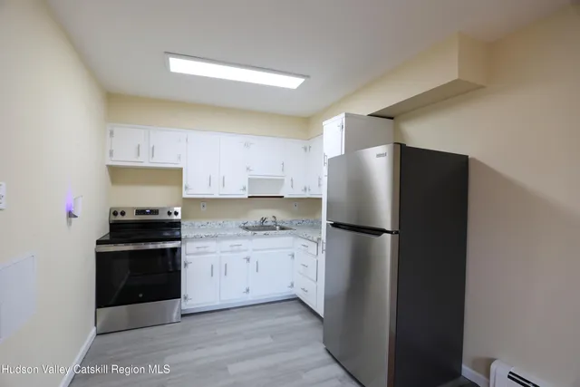 a kitchen with a refrigerator sink and stove