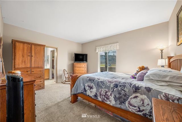 a bedroom with two beds and a tv