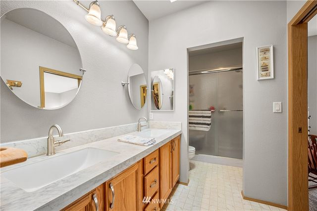 a bathroom with a double vanity sink mirror and double