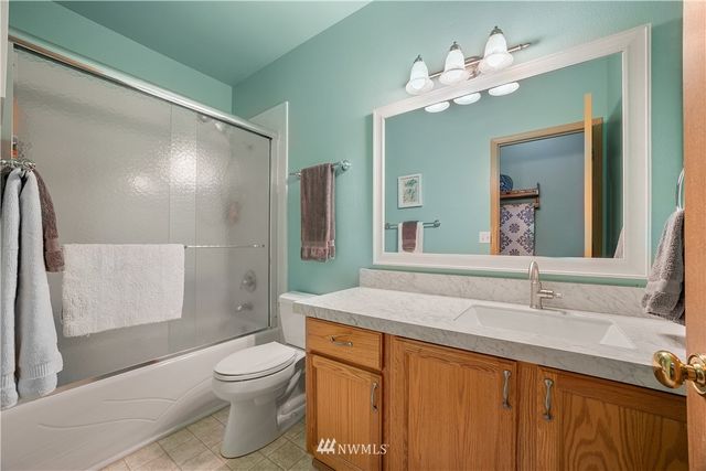 a bathroom with a sink a toilet and a mirror