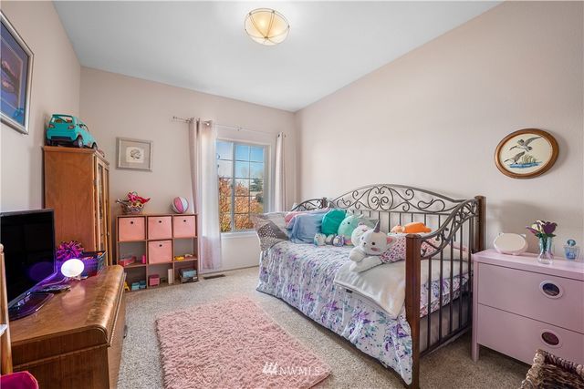 a bedroom with bed and a window