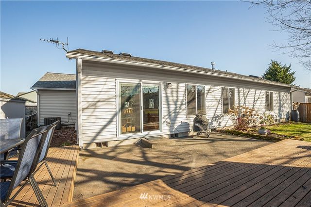 a view of a house with backyard and sitting area