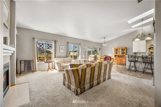 a living room with furniture a fireplace and a table