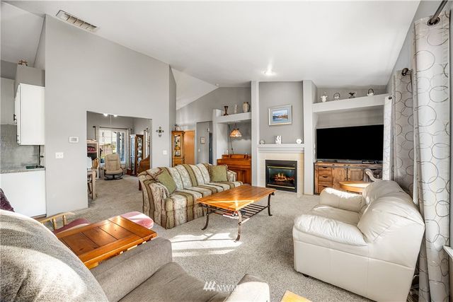 a living room with furniture fireplace and flat screen tv
