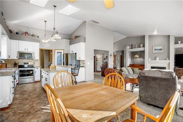 a view of a dining room with furniture and a chandelier