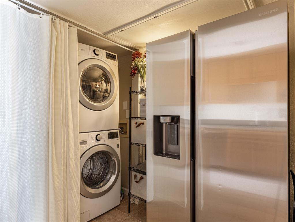9999 Boat Club Road, Unit 601 Fort Worth, TX 76179 - Photo 12 of 39 Clean, organized laundry room equipped with a space-saving stackable washer and dryer.