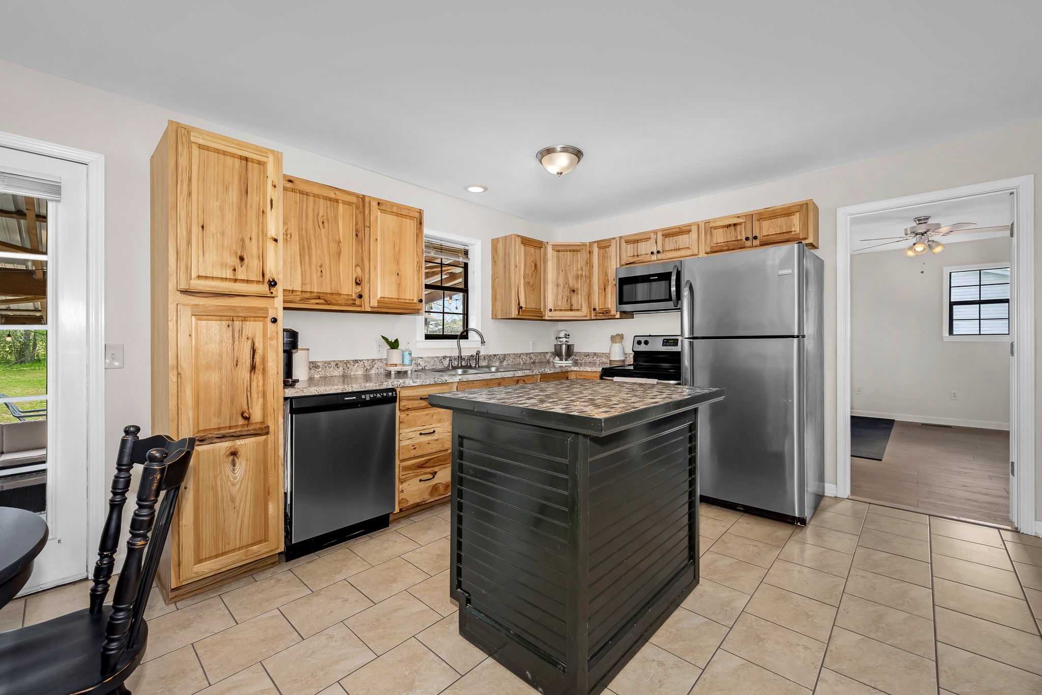 210 Sunset Street Unionville, TN 37180 - Photo 15 of 48 a kitchen with kitchen island granite countertop a refrigerator stove top oven and sink