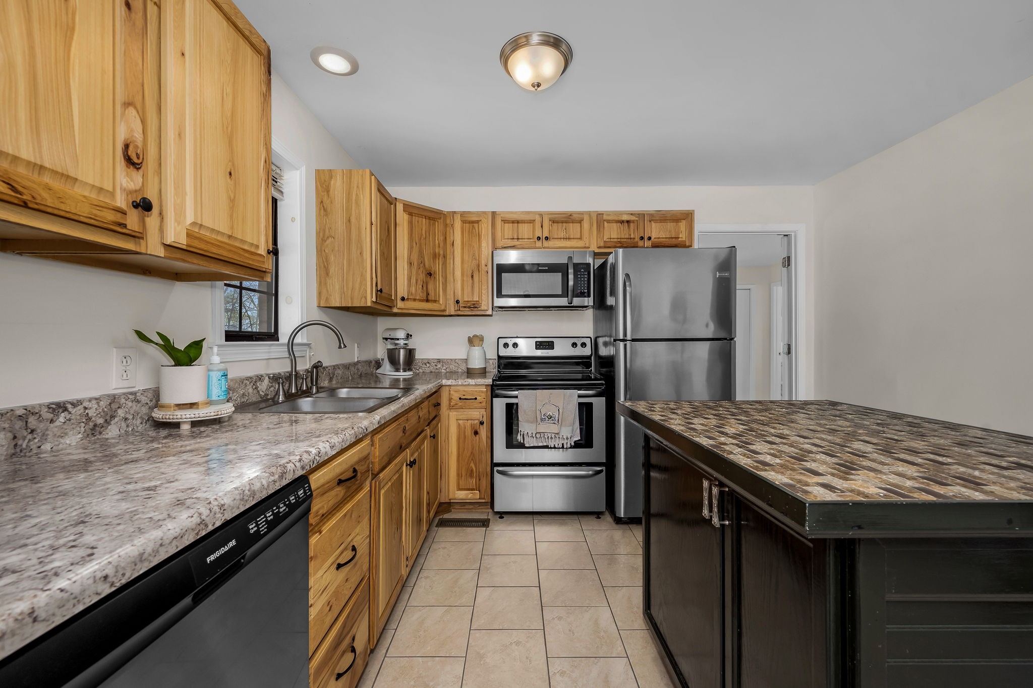 210 Sunset Street Unionville, TN 37180 - Photo 16 of 48 a kitchen with stainless steel appliances granite countertop a sink stove and refrigerator