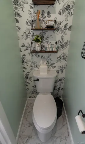 a white toilet sitting next to a shower