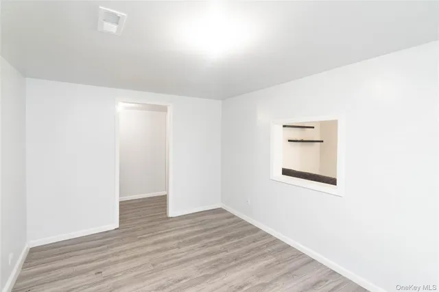 a view of a room with wooden floor