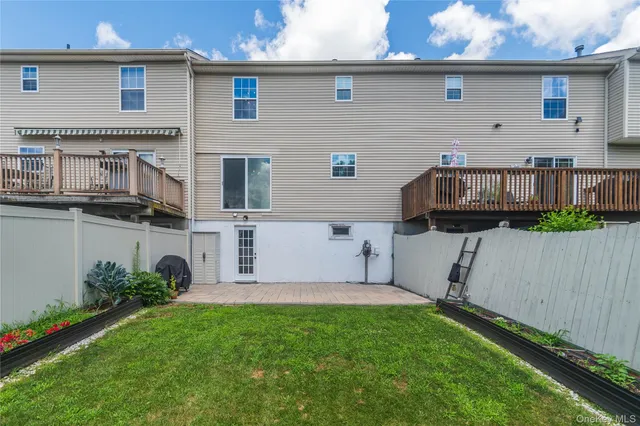 aerial view of a house with backyard and deck