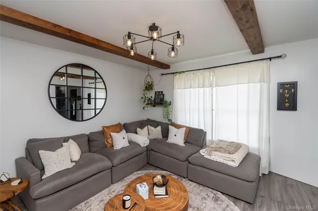 a living room with furniture a rug and a window