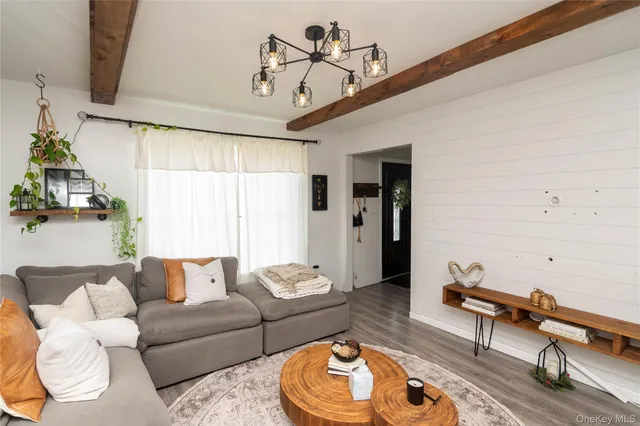 a living room with furniture a rug and a chandelier