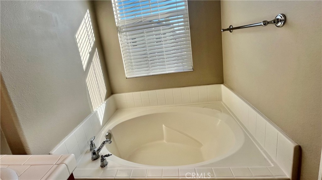 7701 Chambray Place, Unit 2 Rancho Cucamonga, CA 91739 - Photo 16 of 39 a white bath tub sitting in a bathroom