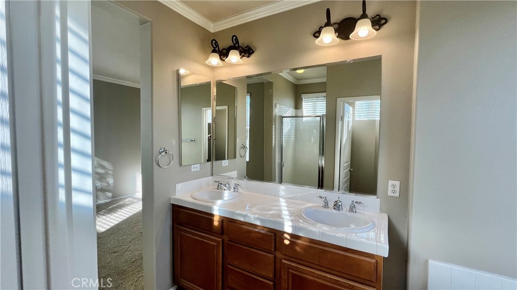 7701 Chambray Place, Unit 2 Rancho Cucamonga, CA 91739 - Photo 17 of 39 a bathroom with a double vanity sink and a mirror