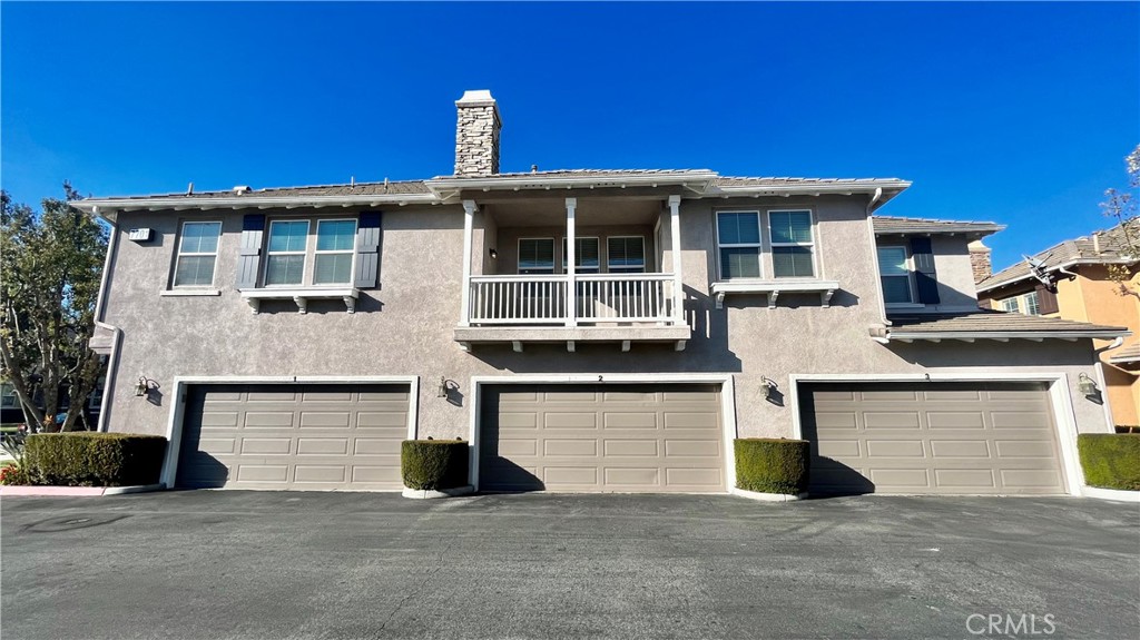 7701 Chambray Place, Unit 2 Rancho Cucamonga, CA 91739 - Photo 2 of 39 a front view of a house with a yard and garage