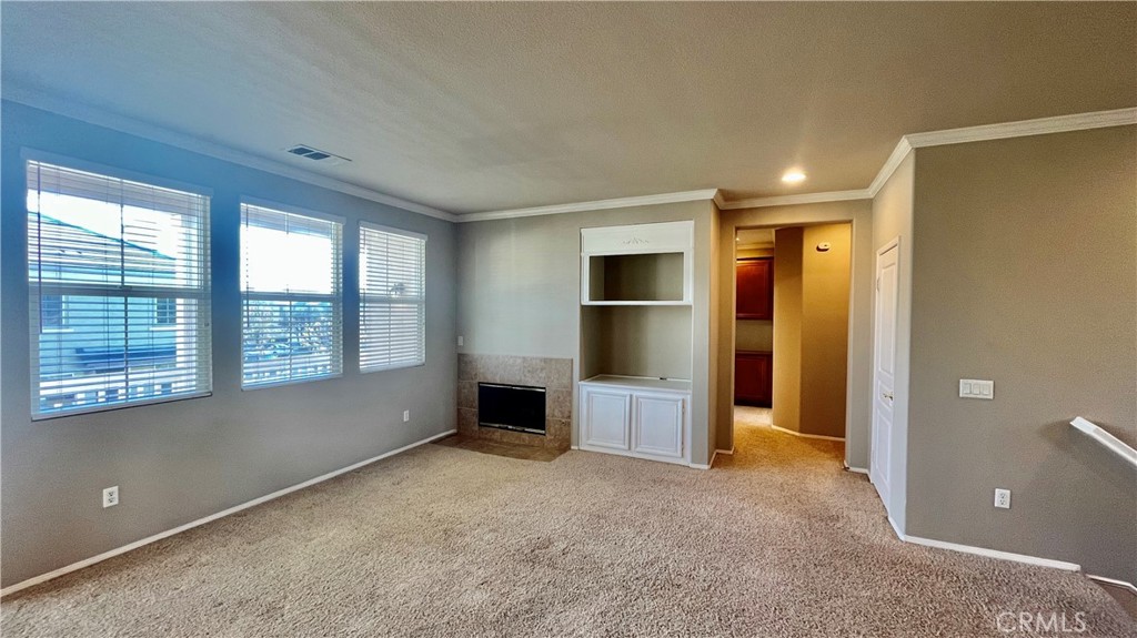 7701 Chambray Place, Unit 2 Rancho Cucamonga, CA 91739 - Photo 3 of 39 a view of empty room with a fireplace and window