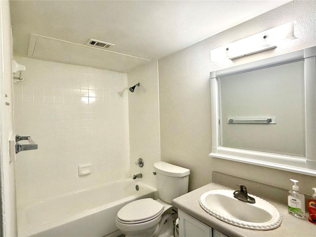 18333 Roehampton Drive, Unit 624 Dallas, TX 75252 - Photo 21 of 39 a bathroom with a sink a toilet and shower
