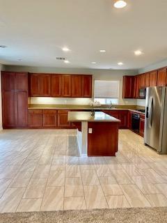 4403 Edam Street Lancaster, CA 93536 - Photo 3 of 20 a kitchen with stainless steel appliances granite countertop a stove a sink dishwasher and a refrigerator