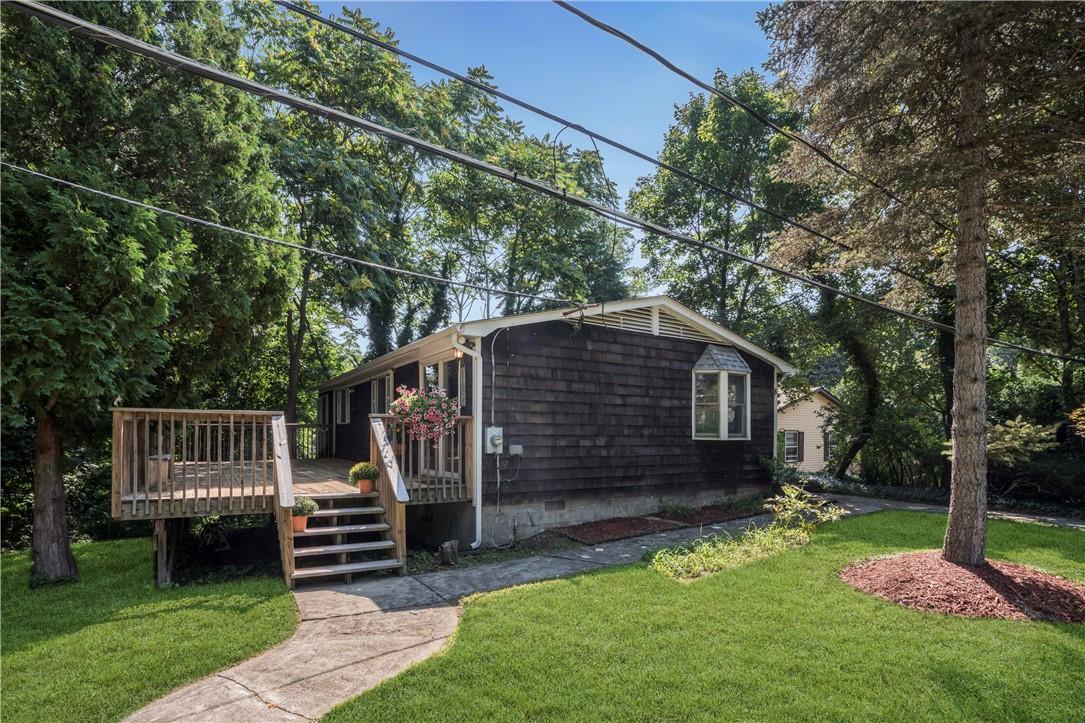 a front view of a house with a garden