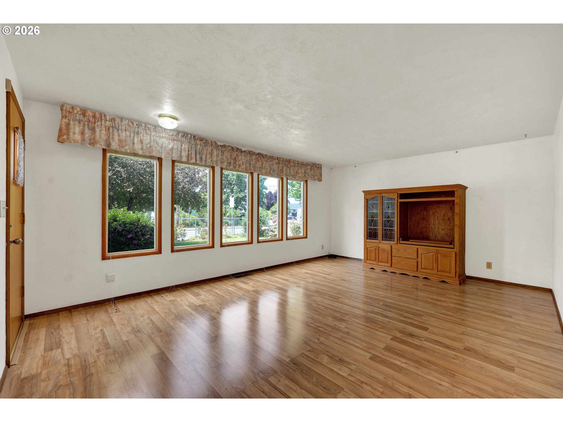1425 Taney Street Eugene, OR 97402 - Photo 4 of 34 a view of an empty room with wooden floor and a window