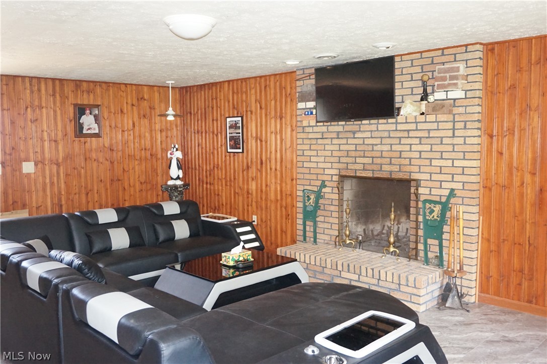 6019 New London Road Ashtabula, OH 44004 - Photo 21 of 47 Rec room with new vinyl tile, wood burning fireplace and wet bar.
