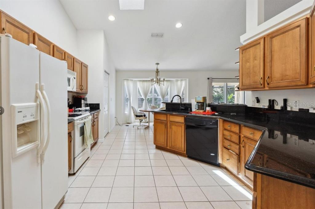 4300 Northwest 4th Circle Ocala, FL 34475 - Photo 11 of 34 a kitchen with stainless steel appliances granite countertop a refrigerator and a stove top oven