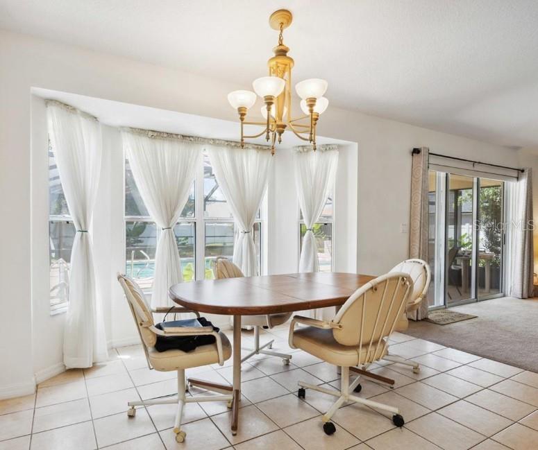 4300 Northwest 4th Circle Ocala, FL 34475 - Photo 12 of 34 a dining room filled with furniture and large windows