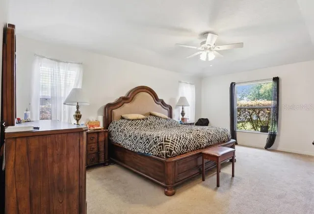 a bedroom with a bed chair and window