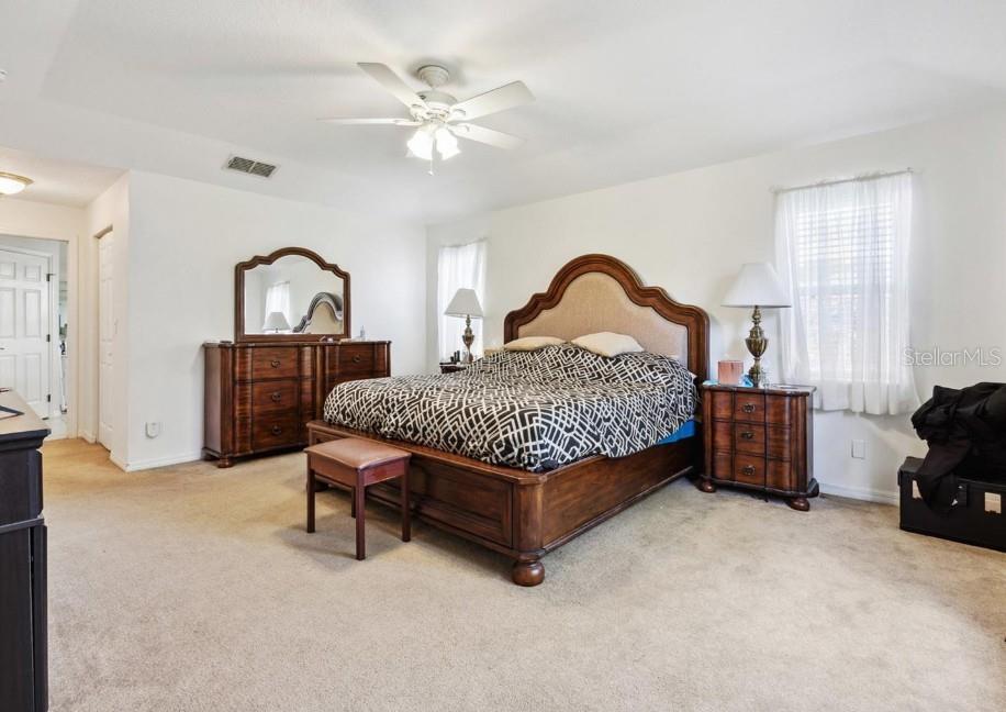 4300 Northwest 4th Circle Ocala, FL 34475 - Photo 15 of 34 a bedroom with a bed chair and a dresser