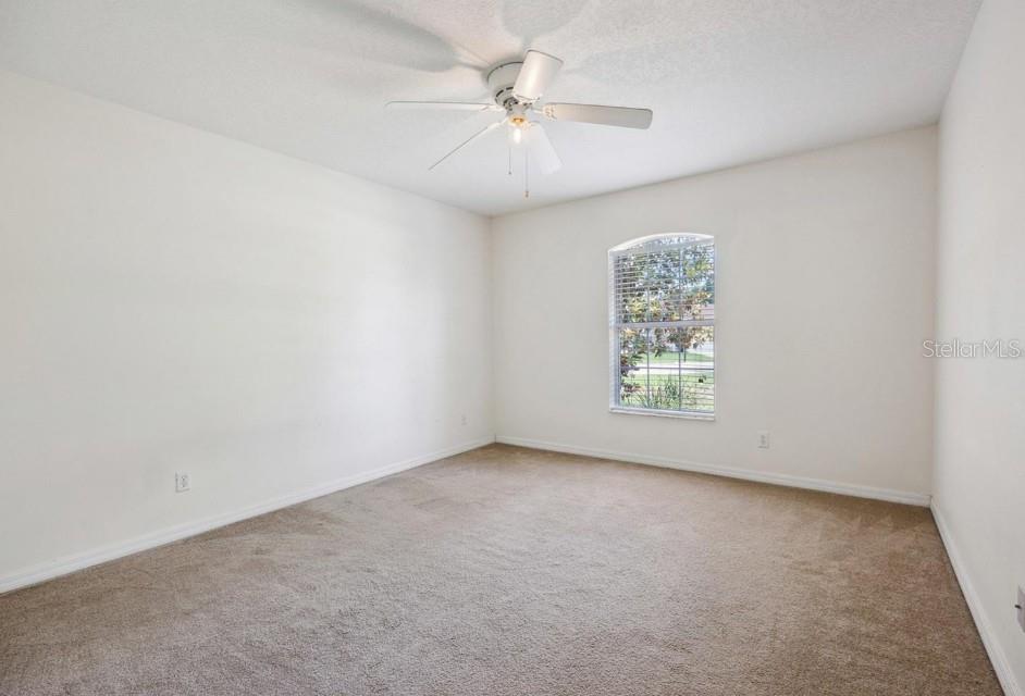 4300 Northwest 4th Circle Ocala, FL 34475 - Photo 17 of 34 an empty room with windows and fan