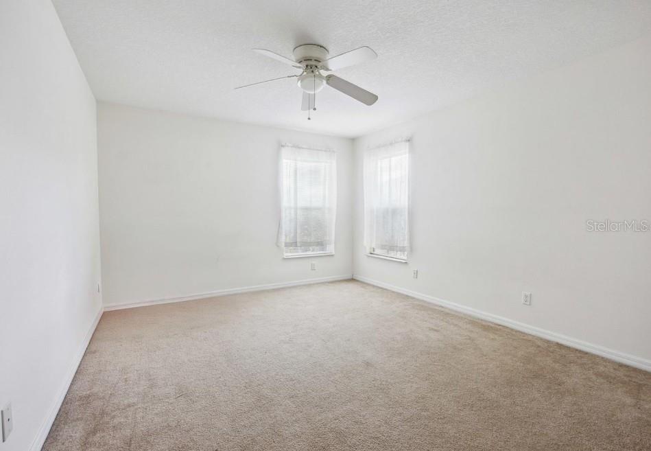 4300 Northwest 4th Circle Ocala, FL 34475 - Photo 19 of 34 an empty room with a ceiling fan and a window