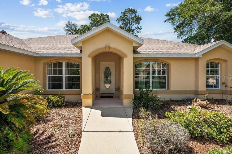 4300 Northwest 4th Circle Ocala, FL 34475 - Photo 2 of 34 a front view of a house with garden