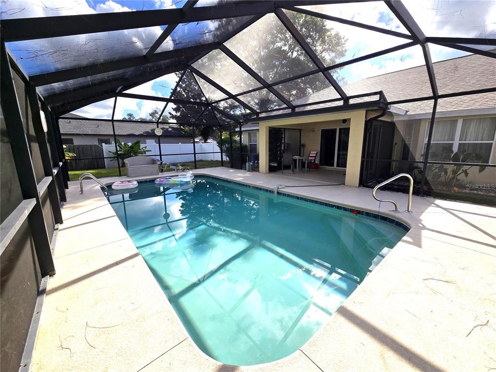 4300 Northwest 4th Circle Ocala, FL 34475 - Photo 26 of 34 a view of a swimming pool with a patio