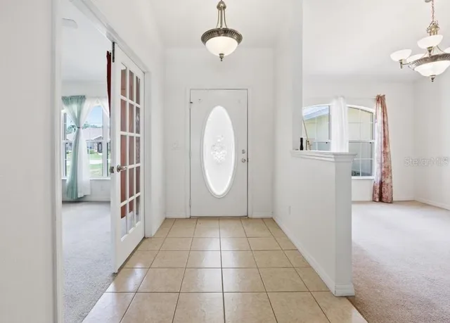 a view of a livingroom with wooden floor and a ceiling fan