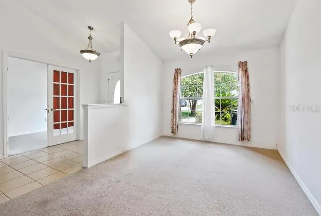 an empty room with windows and outdoor view