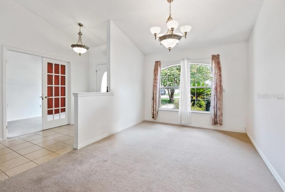 4300 Northwest 4th Circle Ocala, FL 34475 - Photo 5 of 34 an empty room with windows and outdoor view