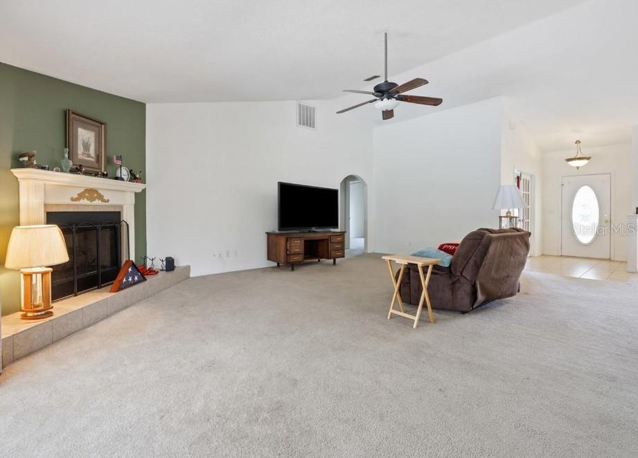 4300 Northwest 4th Circle Ocala, FL 34475 - Photo 8 of 34 a living room with furniture and a fireplace