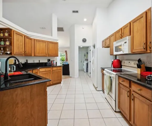 a kitchen with stainless steel appliances granite countertop a sink and cabinets